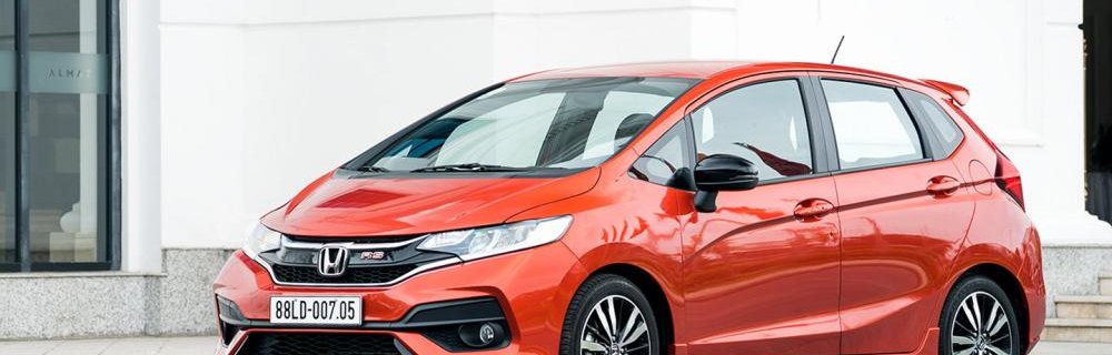 Honda Jazz 2018 red colour park on road front look