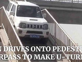 Man Drives an Old Suzuki Jimny Over Pedestrian Overpass For a Quick U-Turn